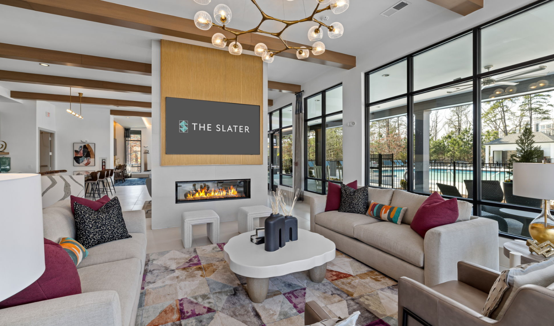 Clubroom with fireplace, seating area and large windows